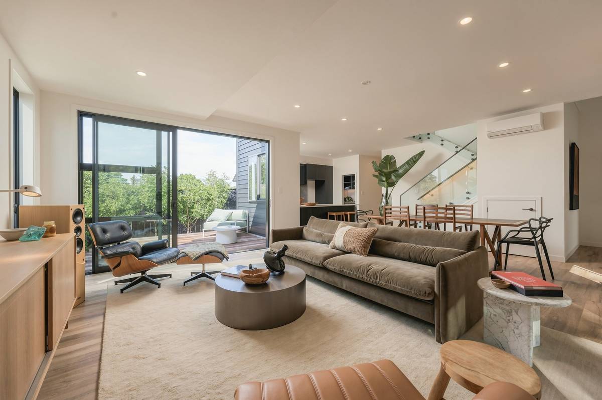 Sunlit living room with floor-to-ceiling glazing, shot in the editorial style