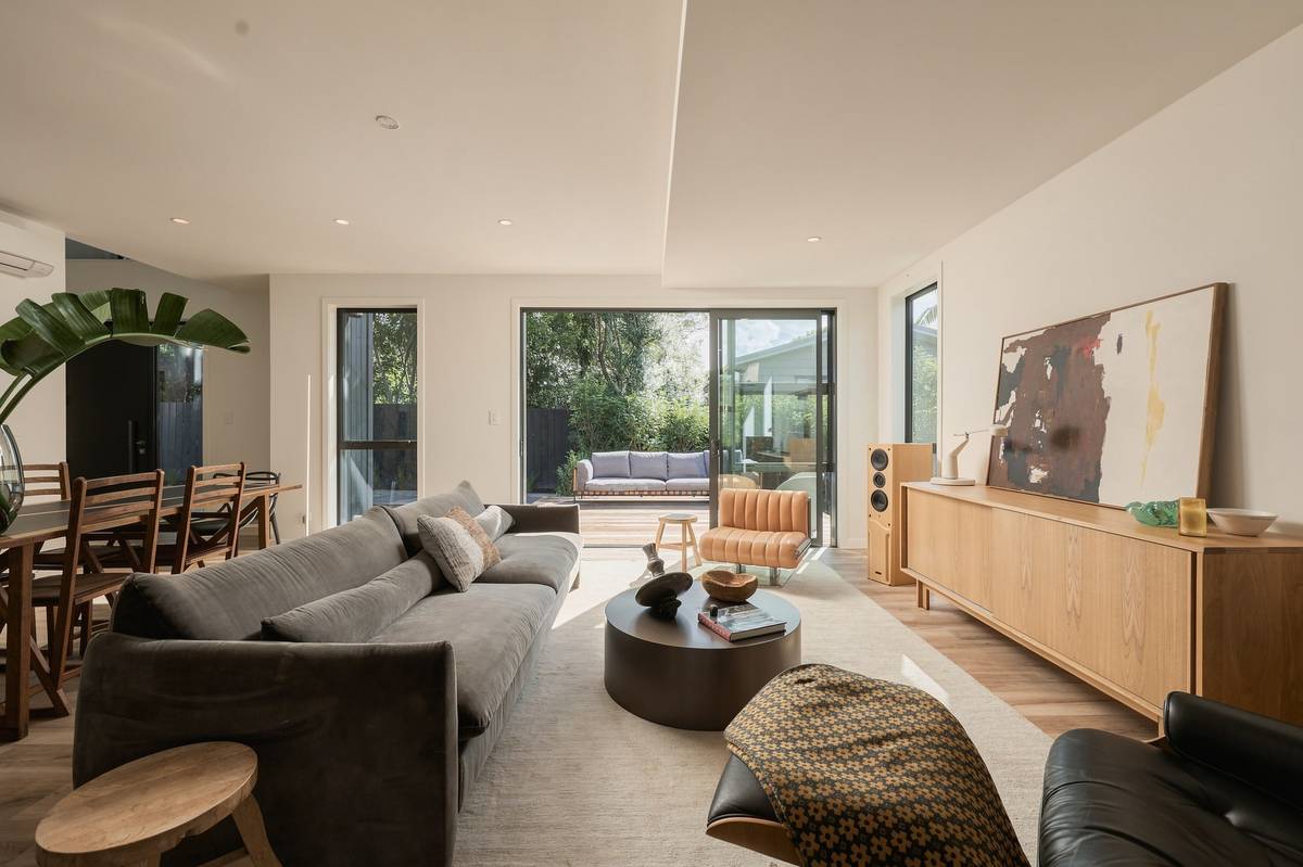 Living room in the Editorial style: warm, directional light with retained shadow